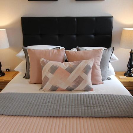 The Larches Hotel Wolverhampton Exterior photo A bed with cushions